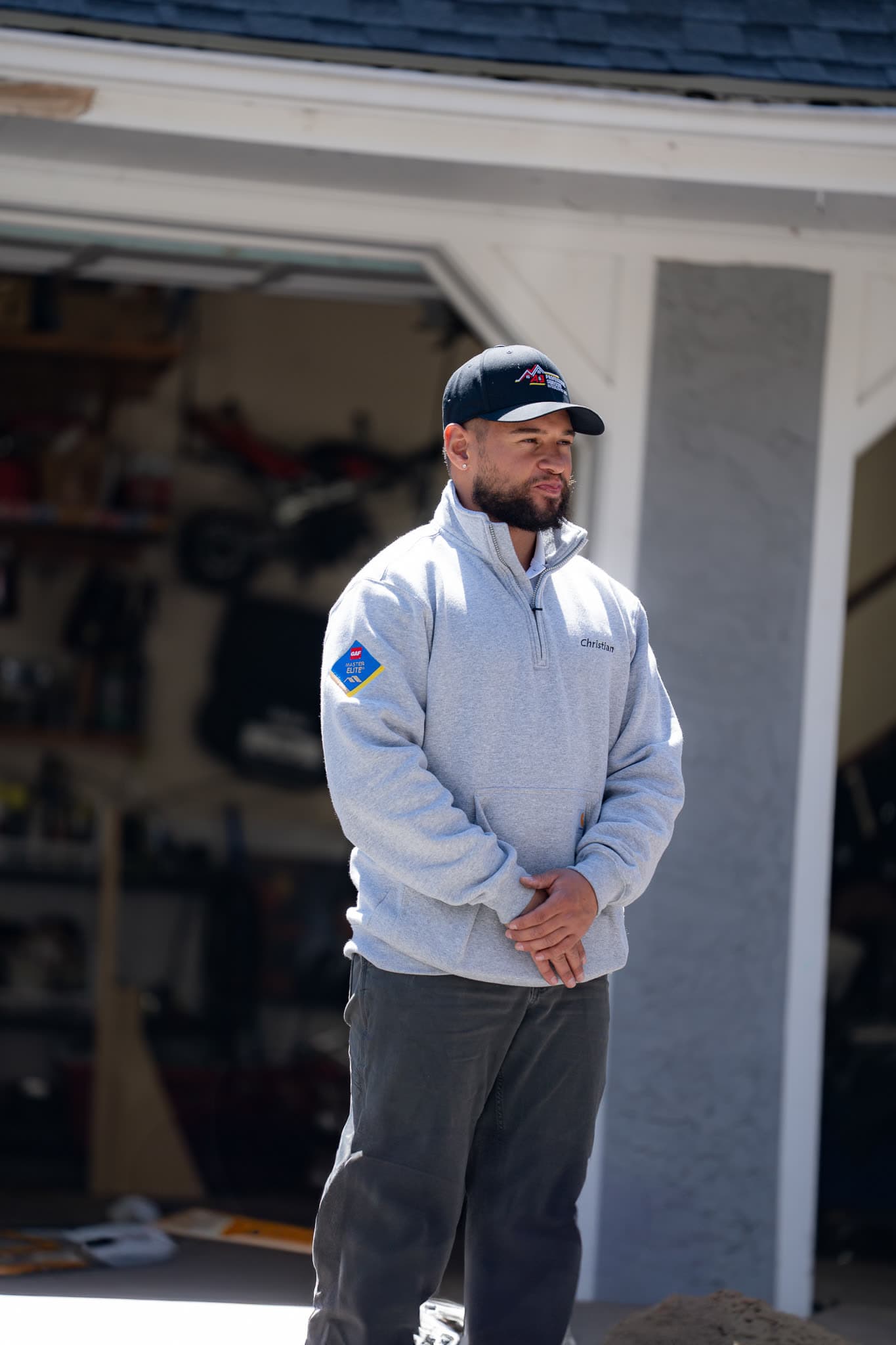 Christian, A&J Professional Services owner, on a job site in a GAF Master Elite pullover