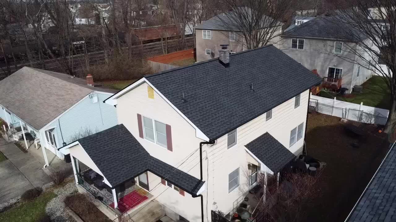 Finished shingle roof over a multi-family home, aerial view