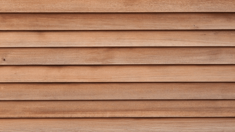 Close-up texture of finished wood-style siding
