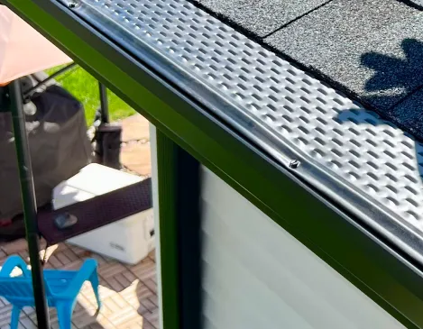Close-up of gutter leaf guard mesh installation