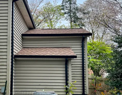 Finished gutters along a siding roofline