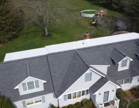 Aerial view of a finished roof over a home with a backyard pool