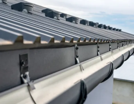 Gutter leaf guard mesh installed along a roof edge
