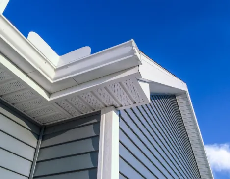 Finished gutter corner detail against a blue sky