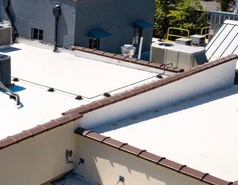 Aerial view of a finished flat commercial roof with rooftop HVAC units
