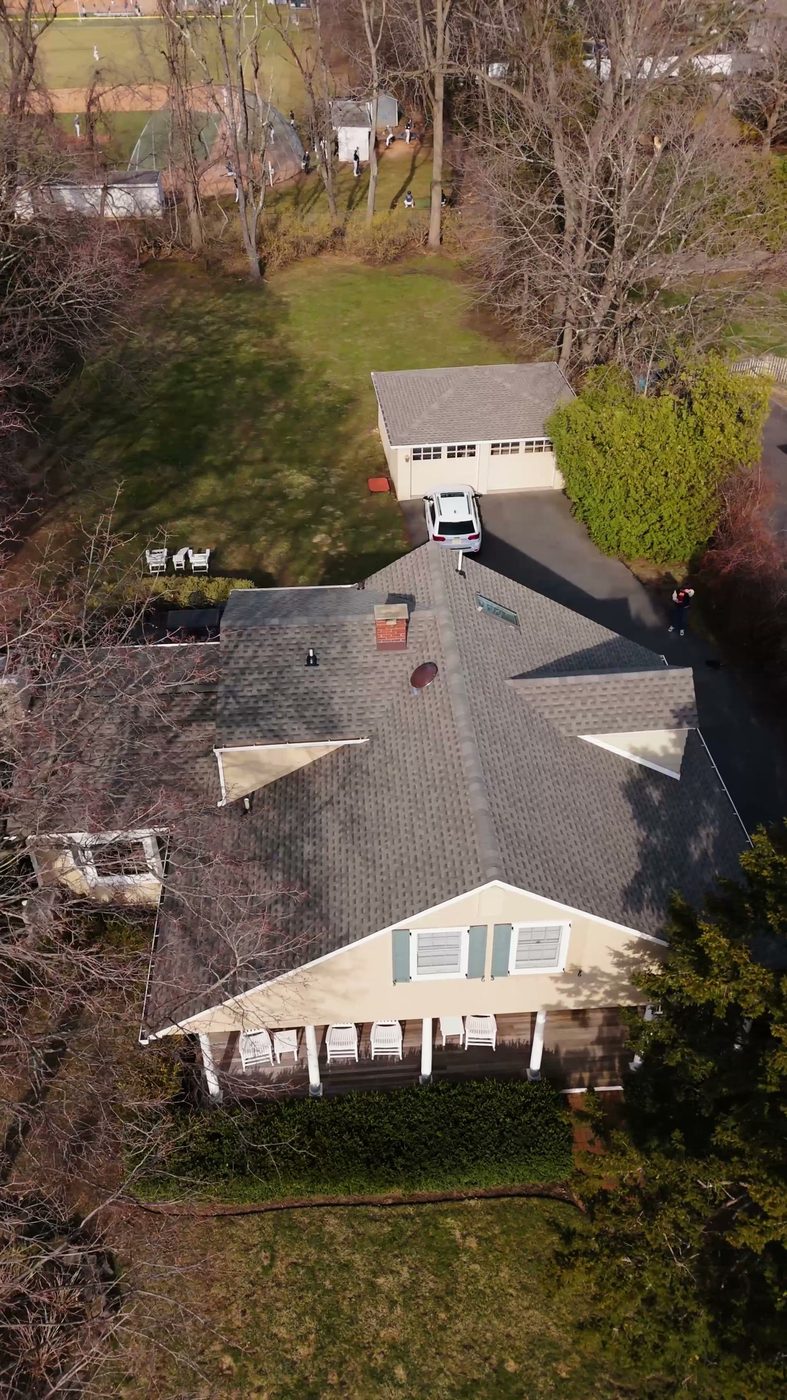 A finished asphalt shingle roof on a single storey ranch, photographed from above