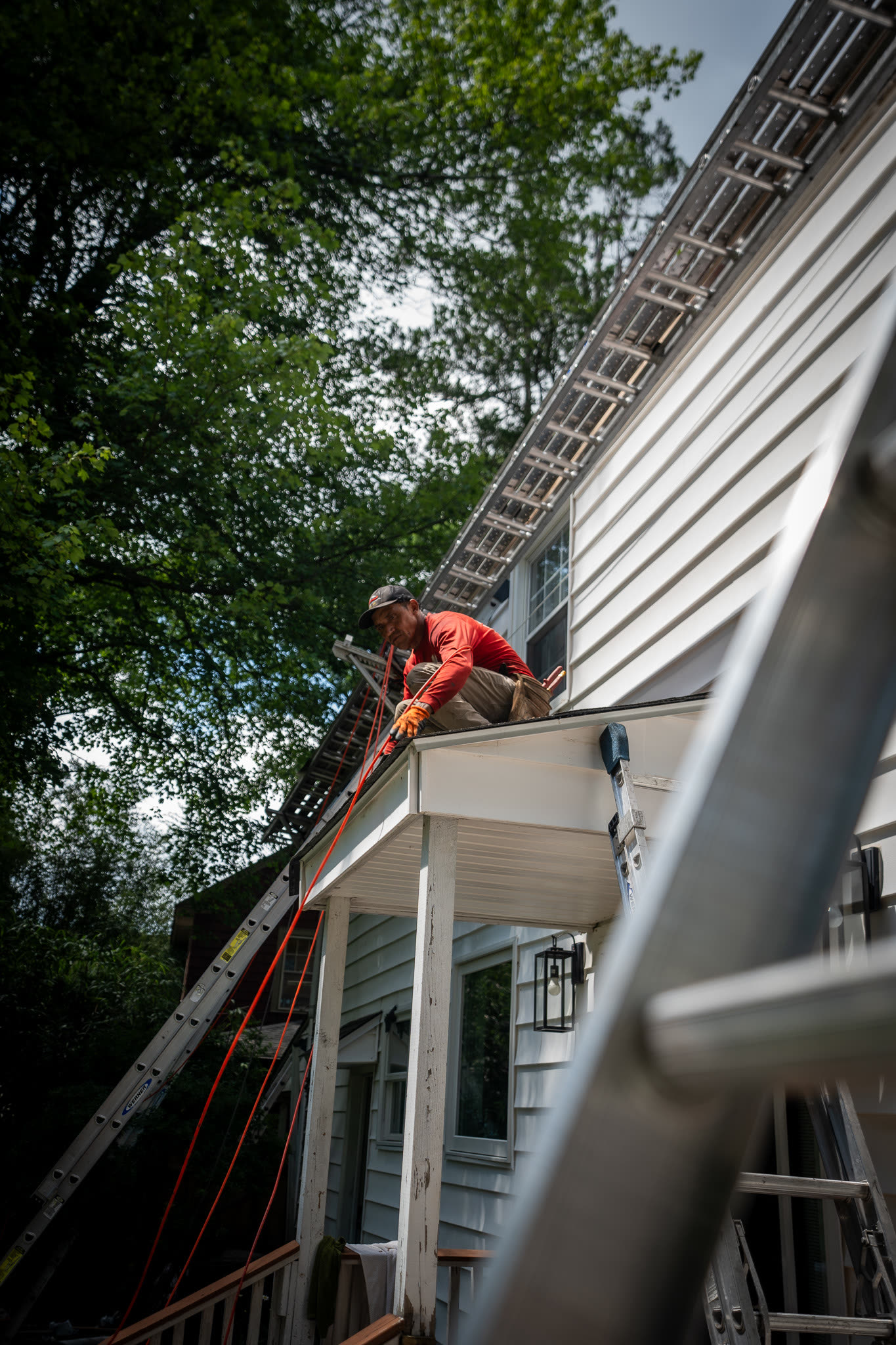 A&J crew installing gutter and fascia along a full porch roofline